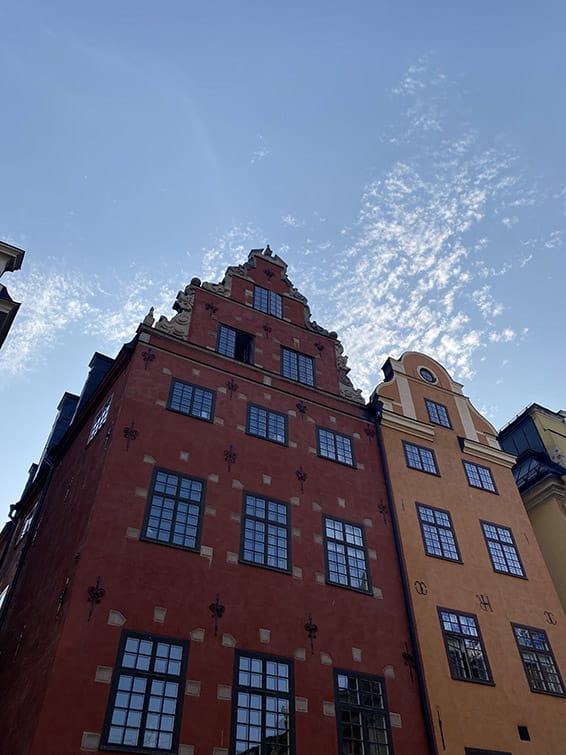 A housefront of a typical old red and yellow Swedish building.