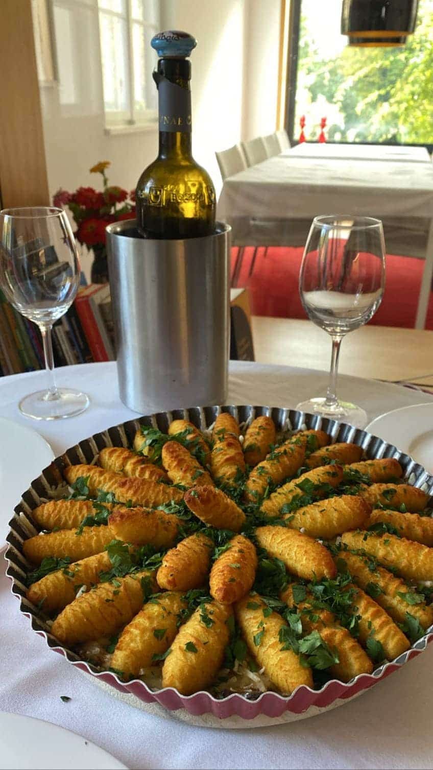 Croquettes on a mushroom sauce. Served with a bottle of white wine.