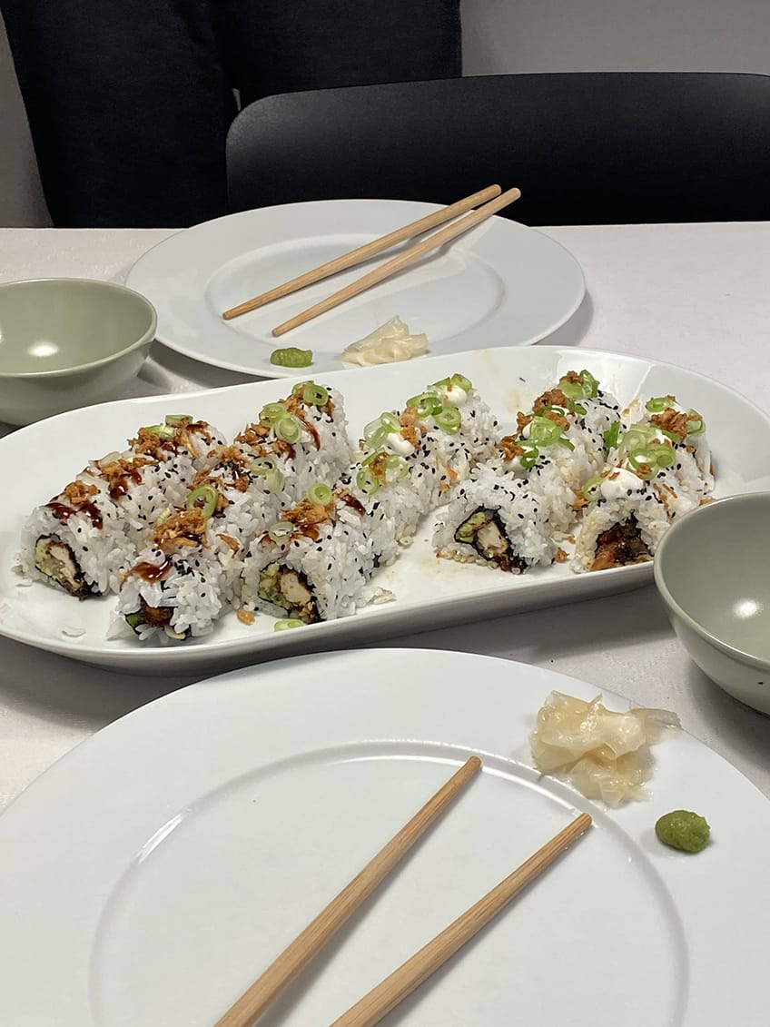 Vegan inside-out maki rolls on a plate.