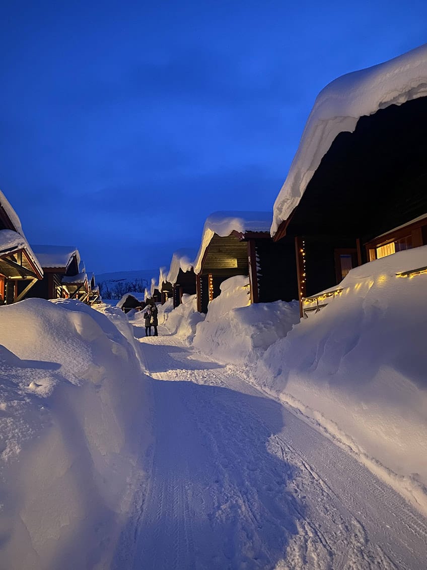 Wodden houses covered in meters of snow.