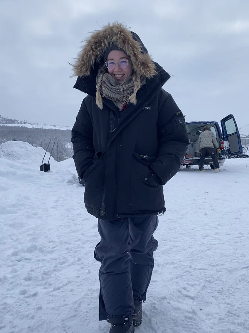 Me, a young woman with blonde braided hair, wearing very thick and warm winter cloth.